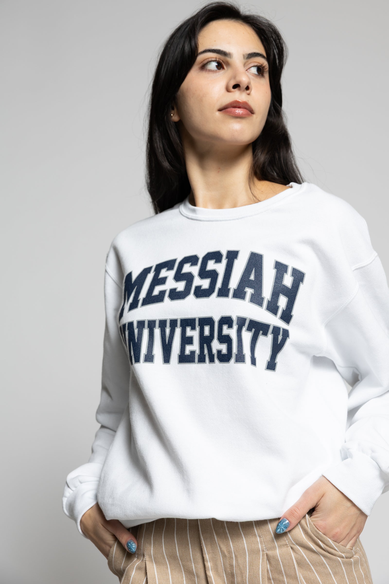 Woman wearing a white sweatshirt with &